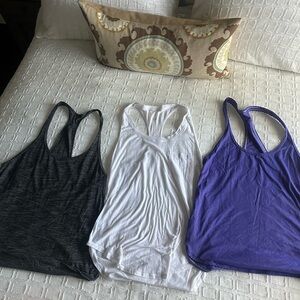 A bundle of 3 lululemon thin tank tops in medium